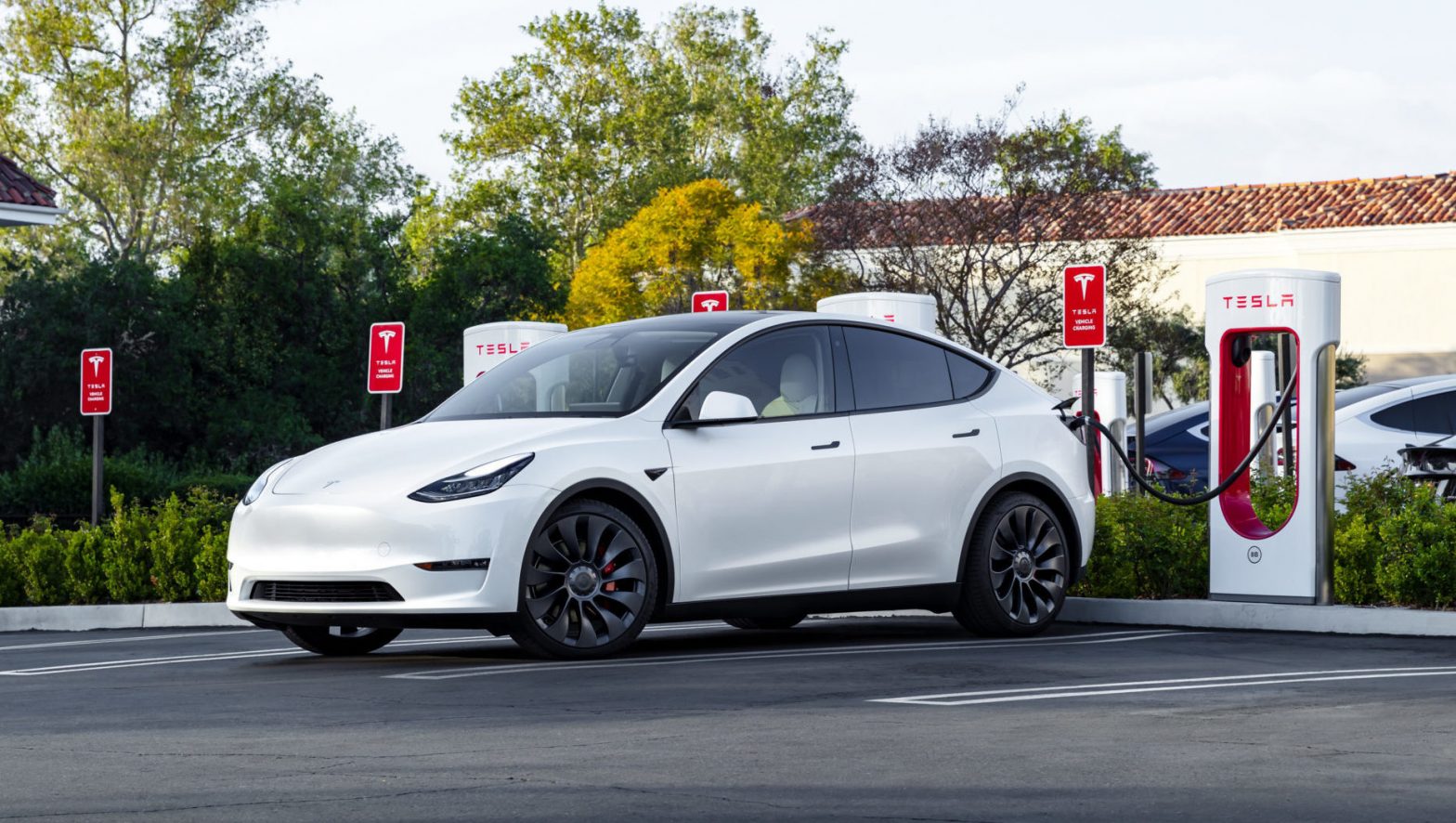 Tesla Model Y charging at a Supercharger station